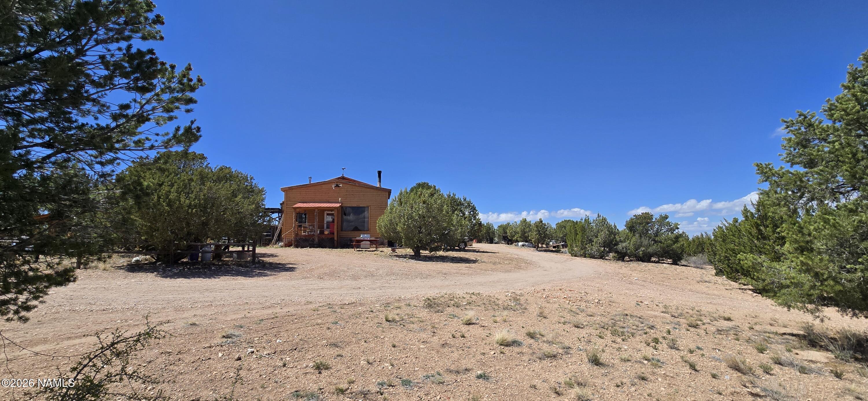 2795 Poppy Road Ash Fork, AZ 86320 - Photo 56 of 56 a front view of a house with a yard covered in snow