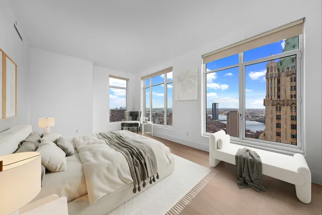 a spacious bedroom with a bed and a large window