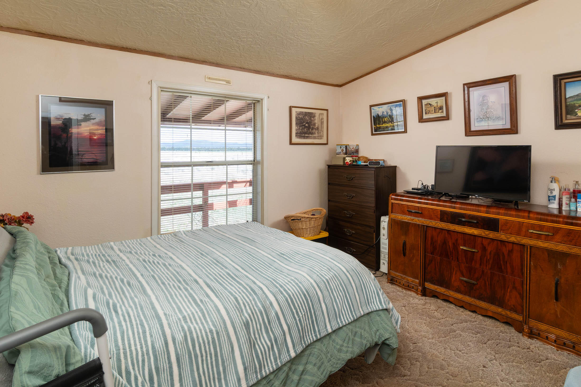 25907 South Cooper Street Bend, OR 97701 - Photo 15 of 34 a bedroom with a bed and a flat screen tv