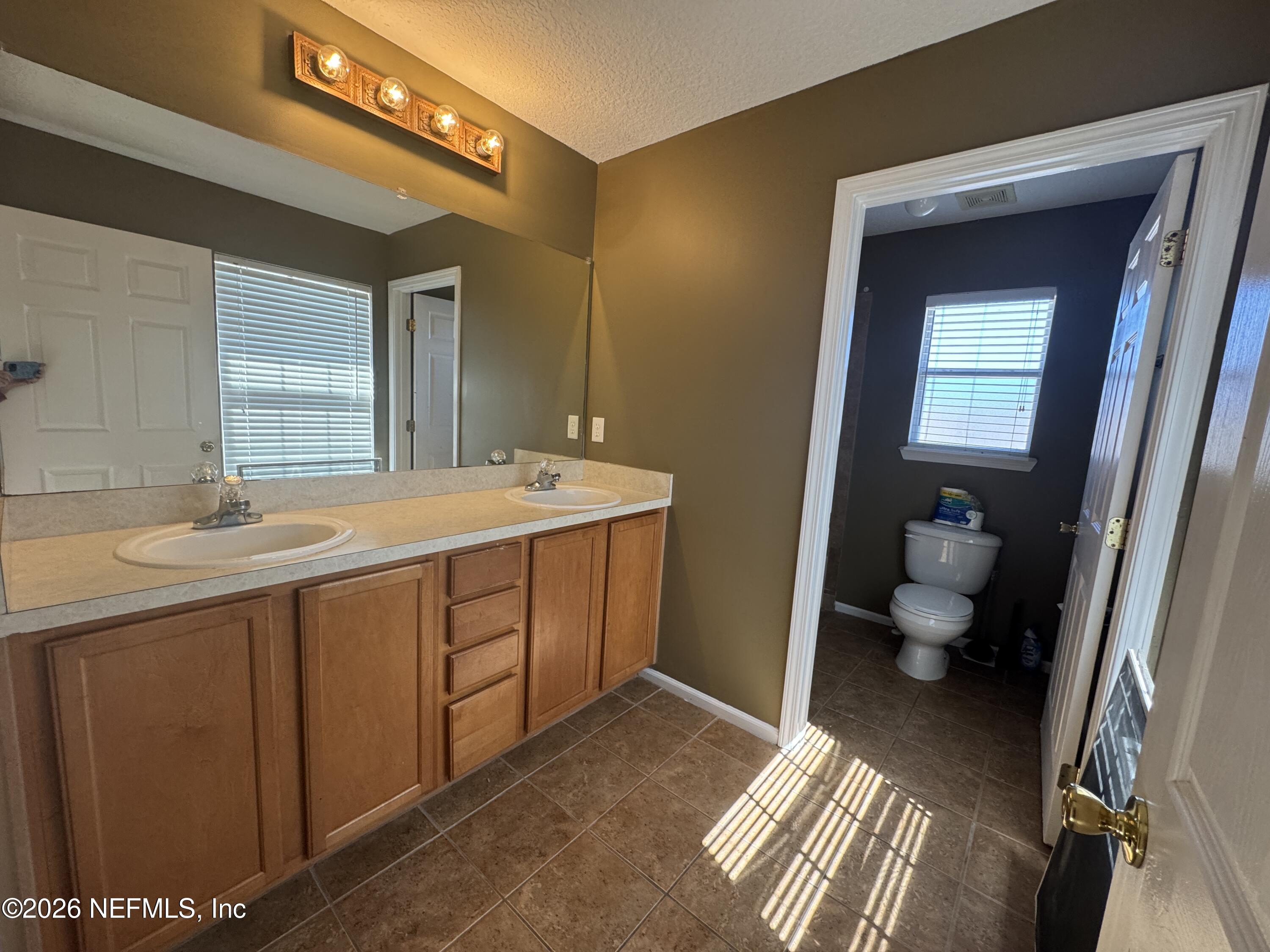 2725 Ravine Hill Drive Middleburg, FL 32068 - Photo 17 of 23 a spacious bathroom with a double vanity sink and a toilet