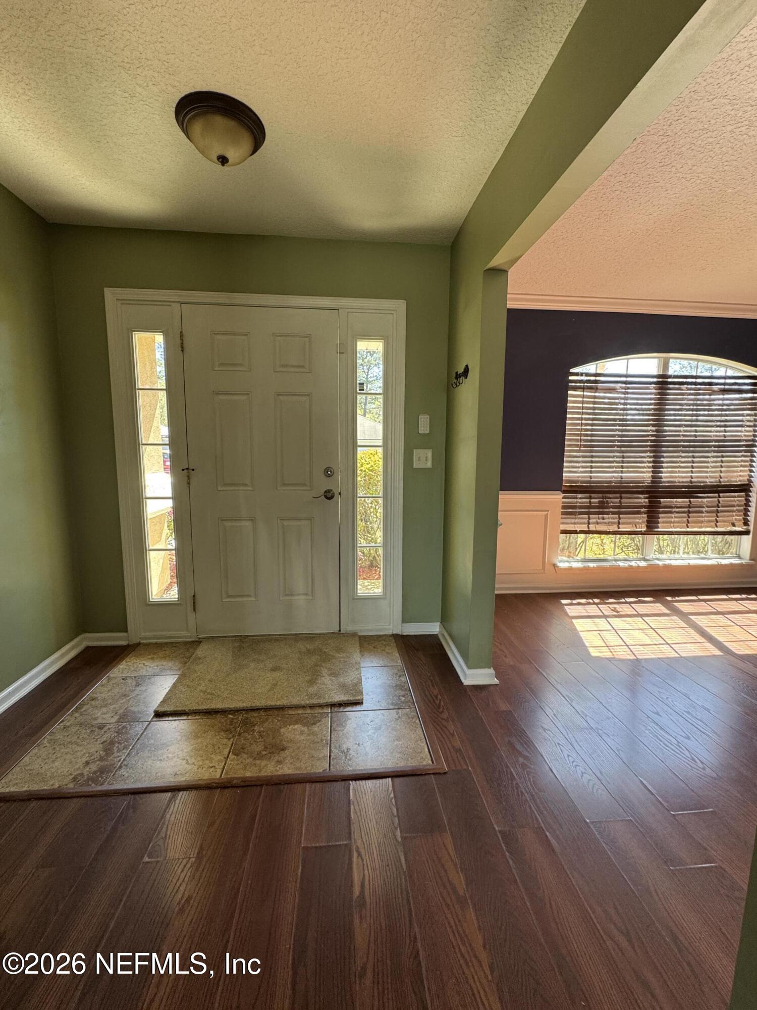 2725 Ravine Hill Drive Middleburg, FL 32068 - Photo 2 of 23 an empty room with wooden floor and windows