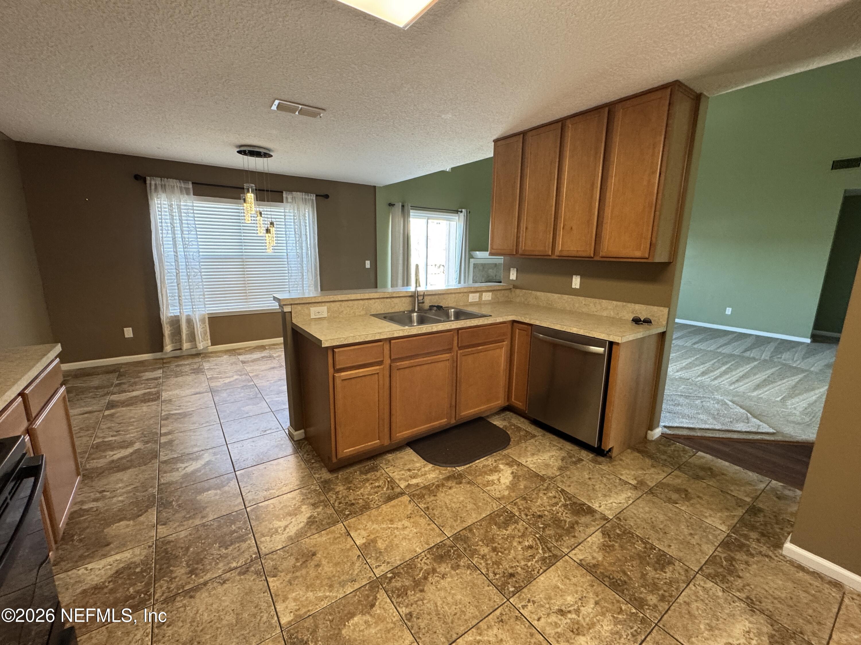 2725 Ravine Hill Drive Middleburg, FL 32068 - Photo 4 of 23 a kitchen with stainless steel appliances granite countertop a sink and cabinets