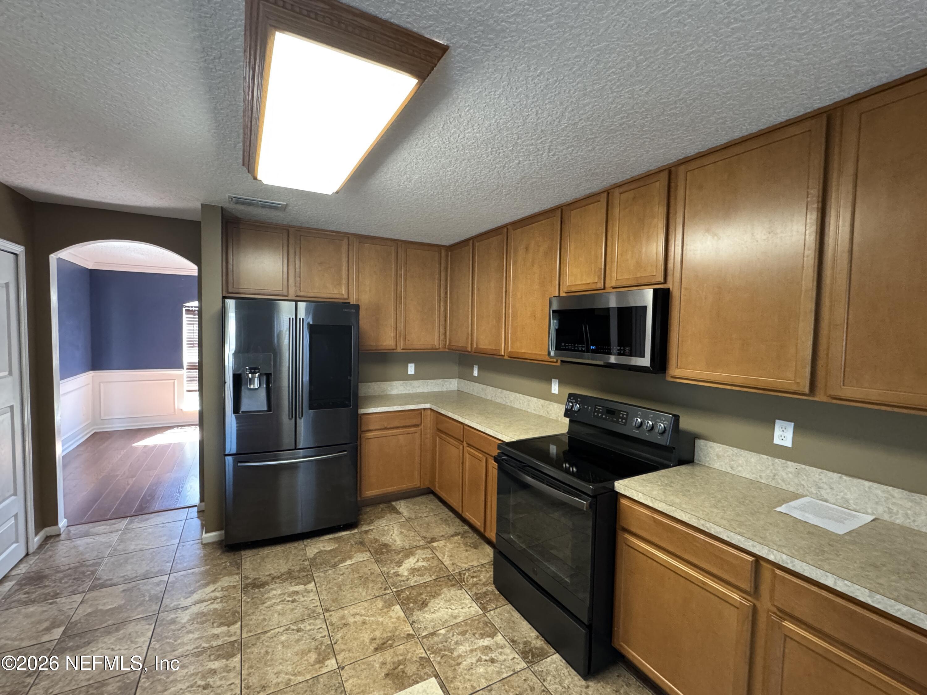 2725 Ravine Hill Drive Middleburg, FL 32068 - Photo 8 of 23 a kitchen with a refrigerator sink and microwave