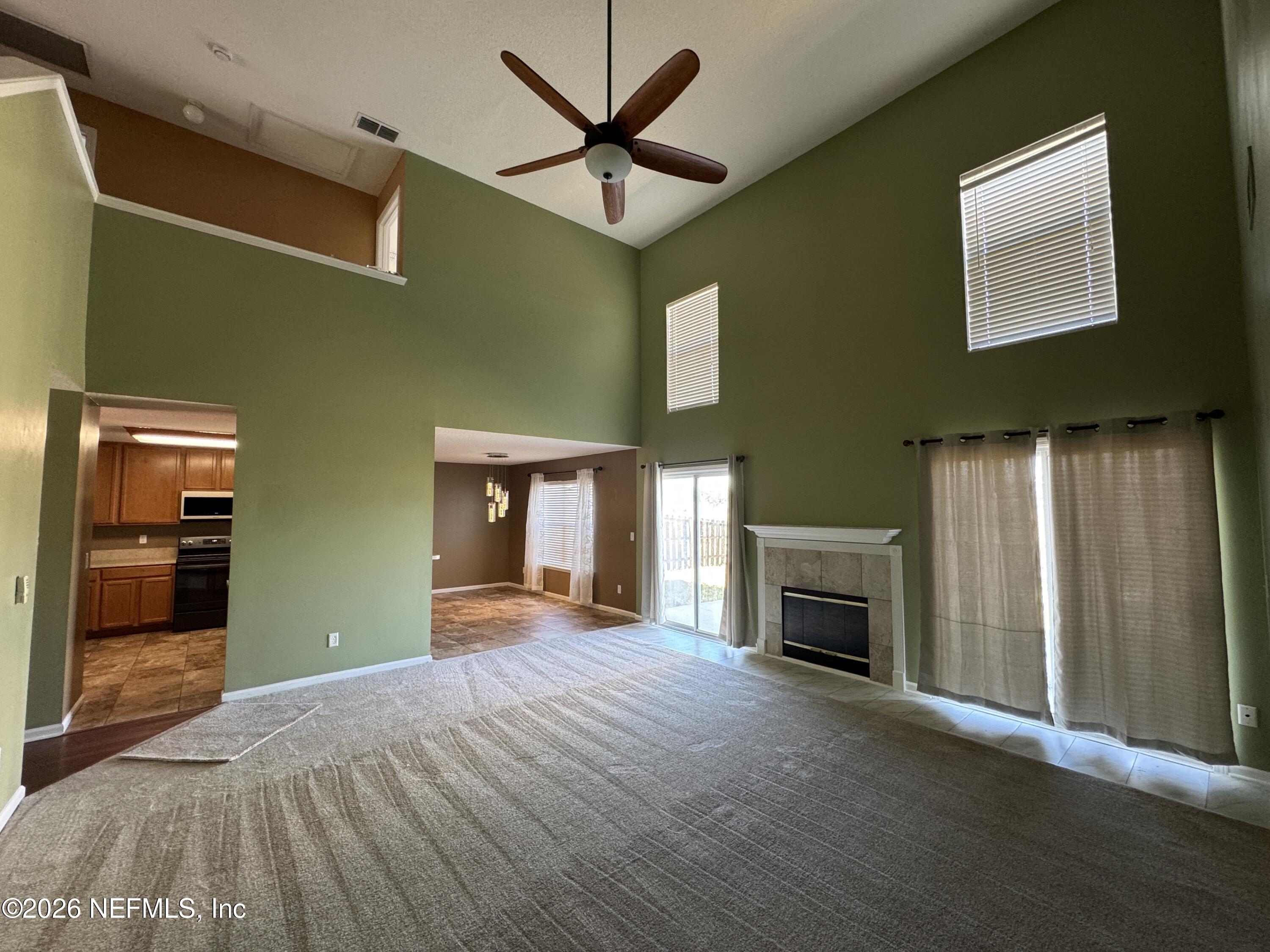 2725 Ravine Hill Drive Middleburg, FL 32068 - Photo 9 of 23 a view of a livingroom with a fireplace a ceiling fan and wooden floor