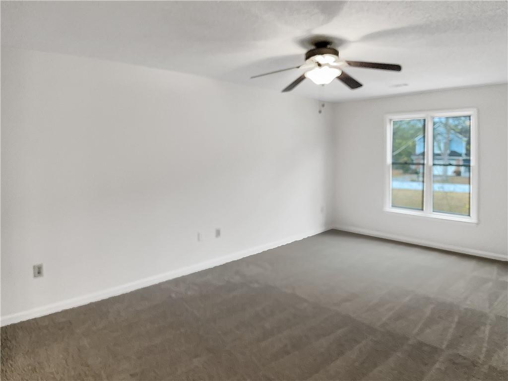 155 Ridgeview Drive Athens, GA 30606 - Photo 12 of 23 an empty room with a chandelier fan and windows