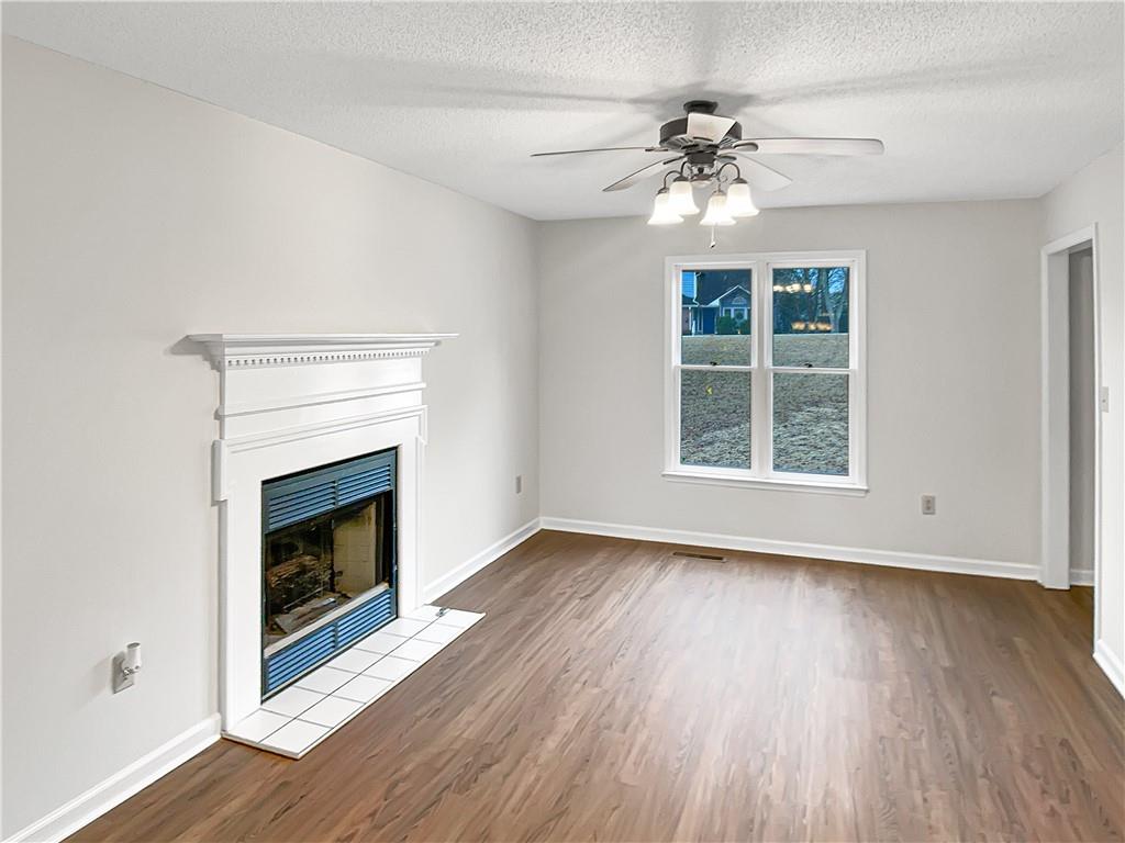 155 Ridgeview Drive Athens, GA 30606 - Photo 5 of 23 a view of an empty room with wooden floor fireplace and a window