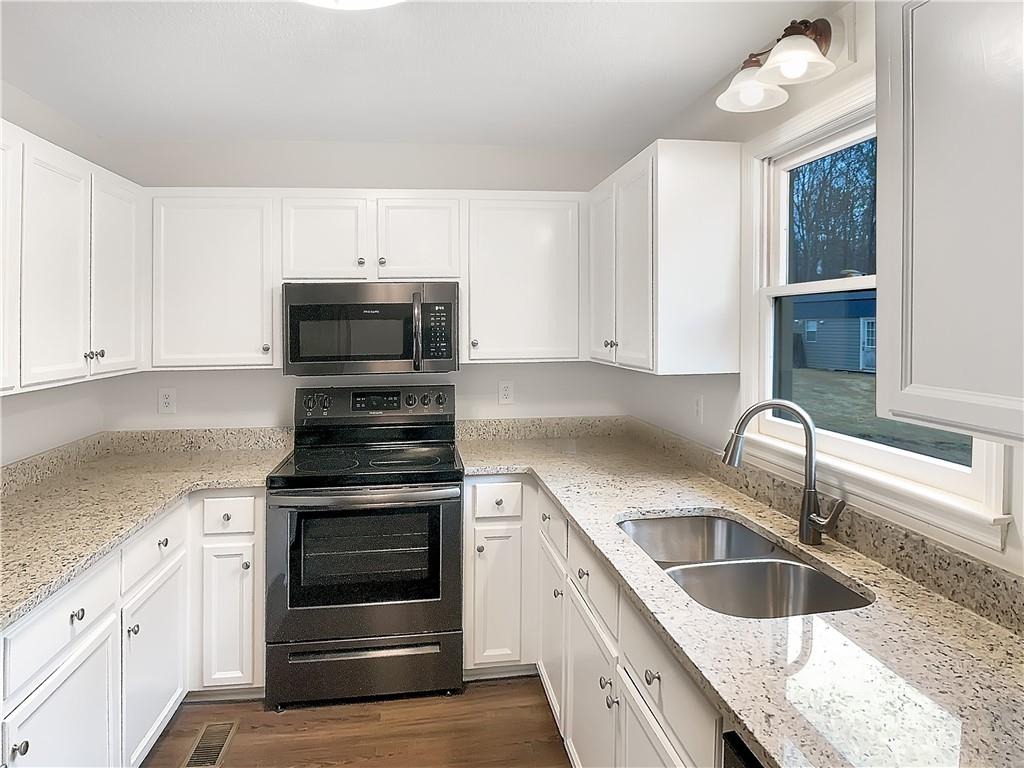 155 Ridgeview Drive Athens, GA 30606 - Photo 8 of 23 a kitchen with granite countertop a sink stainless steel appliances and cabinets