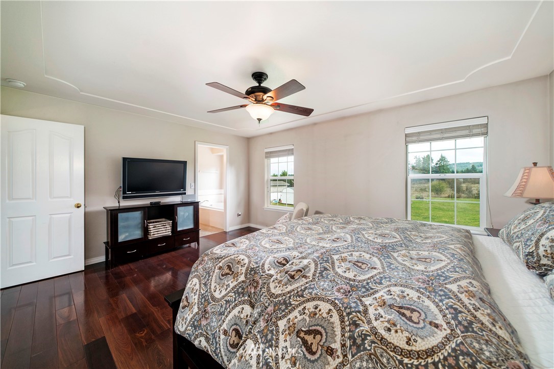 18828 Nutmeg Street Southwest Rochester, WA 98579 - Photo 14 of 25 a bedroom with a bed and a flat screen tv