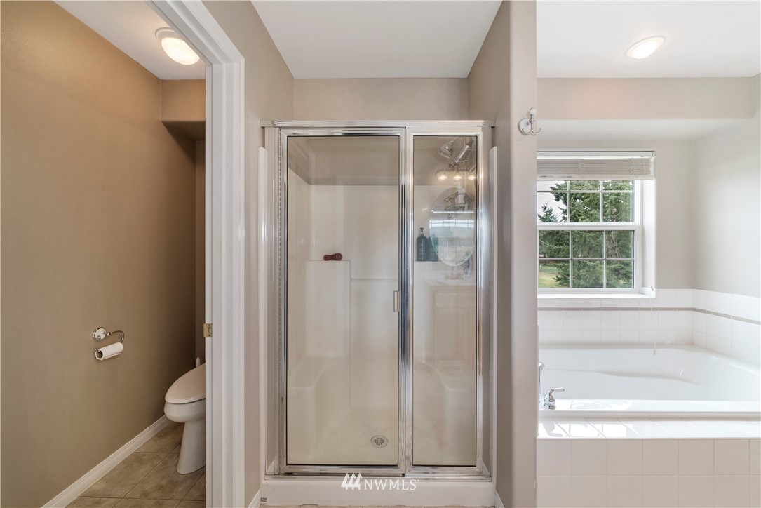 18828 Nutmeg Street Southwest Rochester, WA 98579 - Photo 16 of 25 a bathroom with a glass shower door