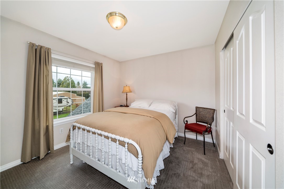 18828 Nutmeg Street Southwest Rochester, WA 98579 - Photo 17 of 25 a bedroom with a bed and a window