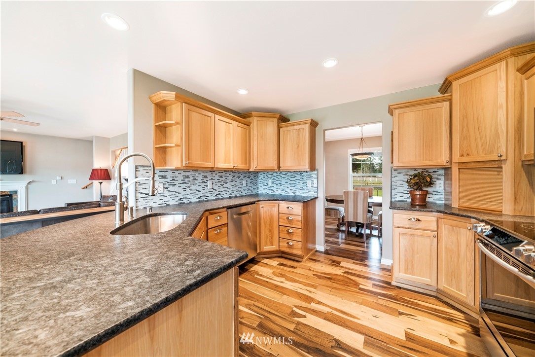 18828 Nutmeg Street Southwest Rochester, WA 98579 - Photo 6 of 25 a kitchen with stainless steel appliances granite countertop a sink stove and cabinets