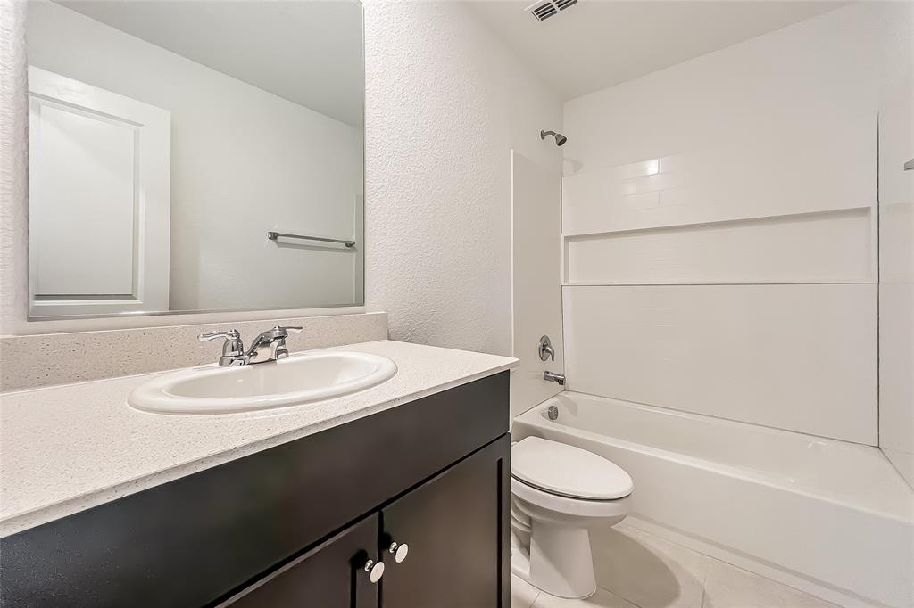 2943 Wallace Wls Court Crandall, TX 75114 - Photo 14 of 16 a bathroom with a sink a toilet and shower