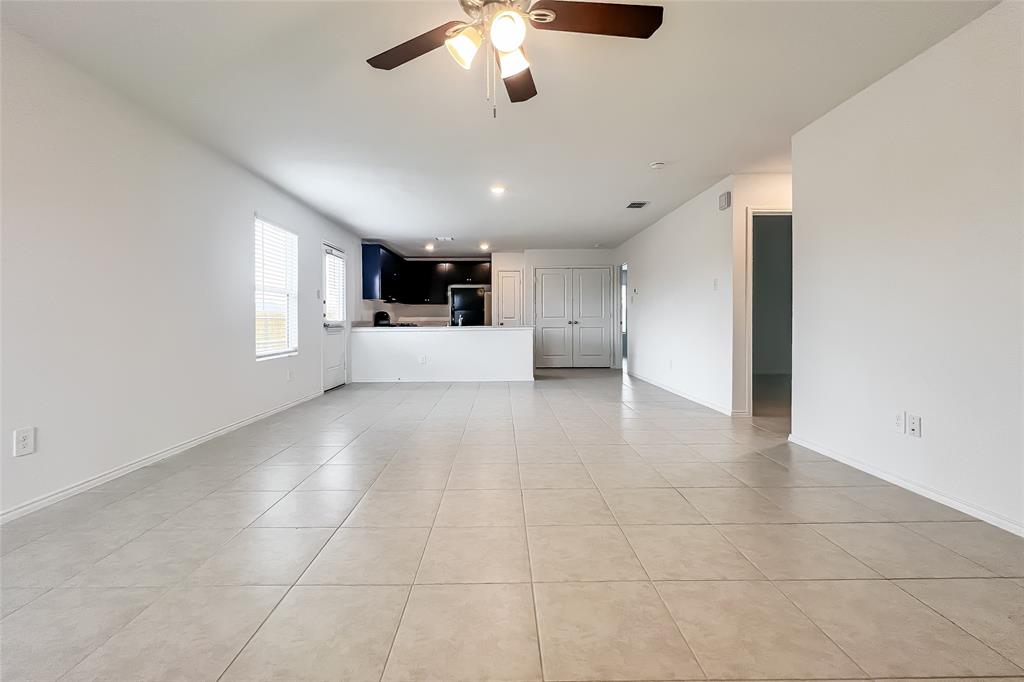 2943 Wallace Wls Court Crandall, TX 75114 - Photo 3 of 16 a view of a big room with windows and chandelier fan