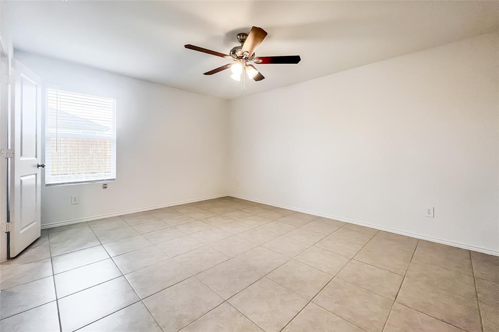 2943 Wallace Wls Court Crandall, TX 75114 - Photo 9 of 16 an empty room with a ceiling fan and window