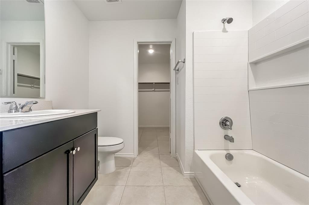 2943 Wallace Wls Court Crandall, TX 75114 - Photo 10 of 16 a bathroom with a bathtub sink vanity and toilet
