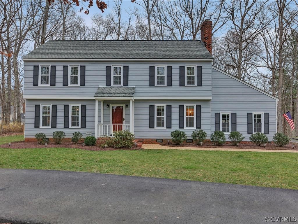 front view of a brick house with a yard