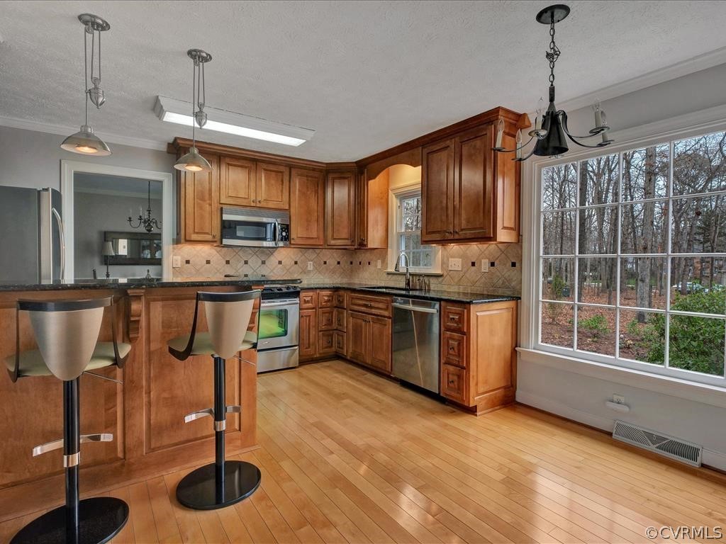 2251 Winterfield Road Midlothian, VA 23113 - Photo 11 of 27 a kitchen with stainless steel appliances granite countertop a stove a sink and a wooden floors