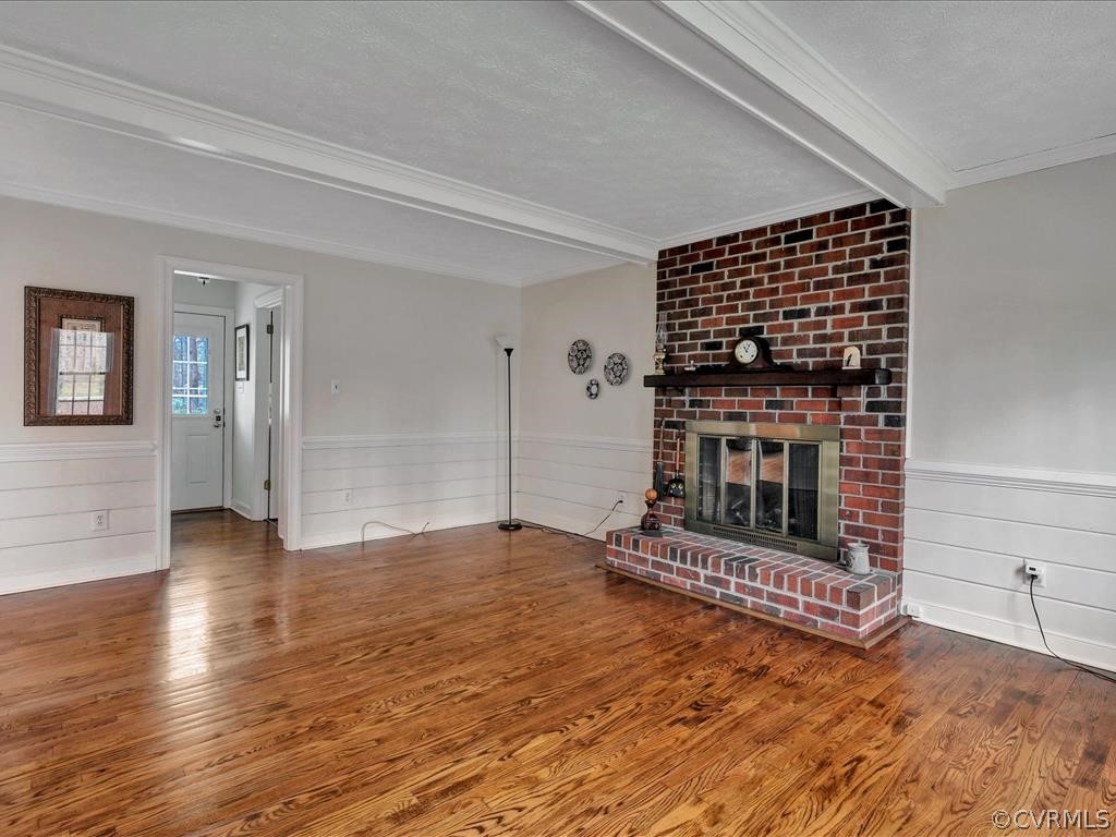 2251 Winterfield Road Midlothian, VA 23113 - Photo 13 of 27 an empty room with wooden floor fireplace and windows