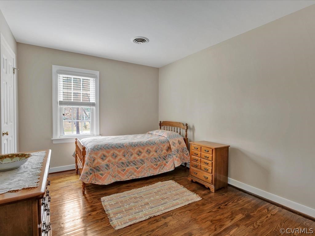 2251 Winterfield Road Midlothian, VA 23113 - Photo 16 of 27 a bedroom with a bed and wooden floor