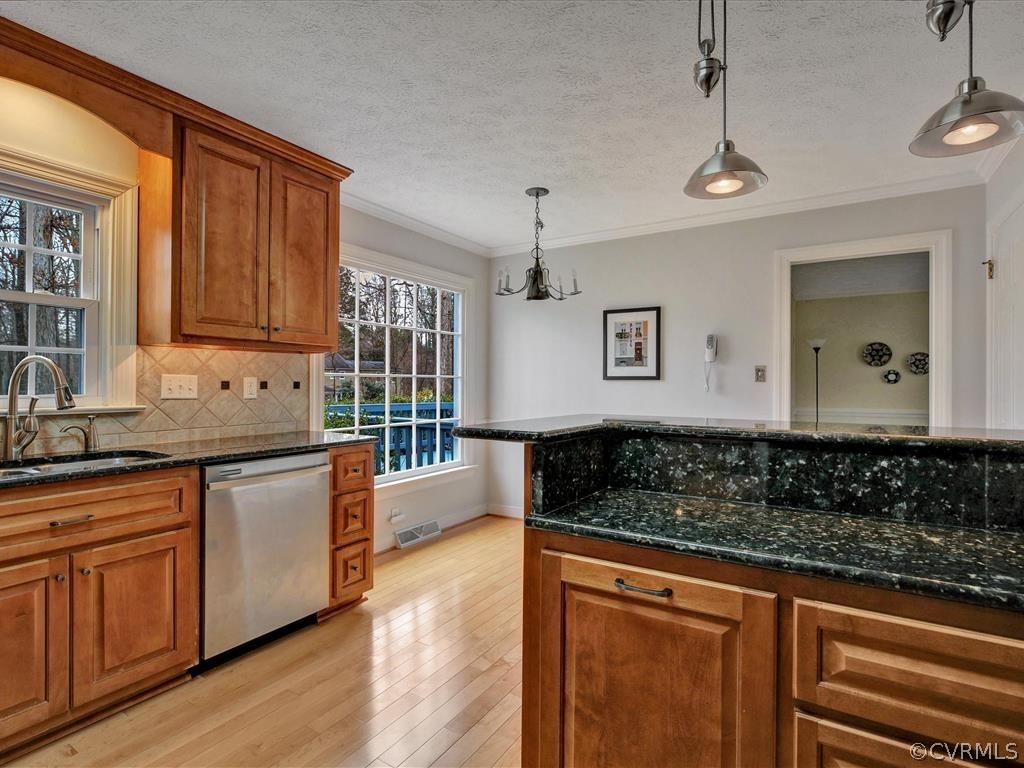 2251 Winterfield Road Midlothian, VA 23113 - Photo 7 of 27 a kitchen with stainless steel appliances granite countertop a sink and wooden cabinets