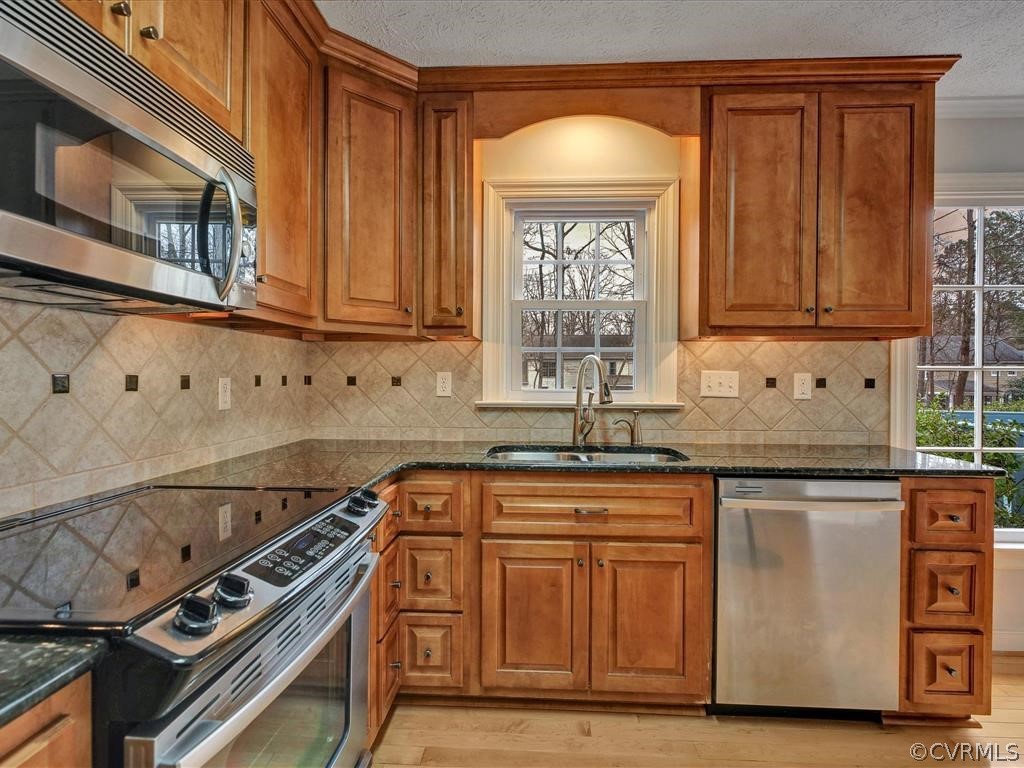 2251 Winterfield Road Midlothian, VA 23113 - Photo 8 of 27 a kitchen with stainless steel appliances granite countertop a stove and a microwave