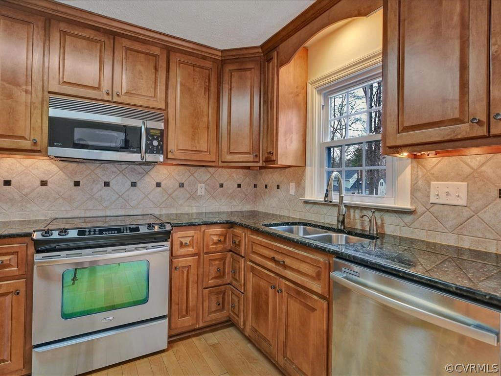 2251 Winterfield Road Midlothian, VA 23113 - Photo 9 of 27 a kitchen with granite countertop cabinets stainless steel appliances and a sink