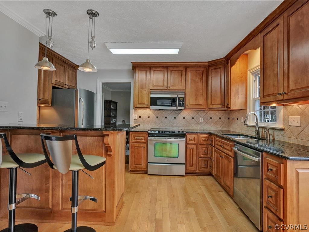 2251 Winterfield Road Midlothian, VA 23113 - Photo 10 of 27 a kitchen with stainless steel appliances granite countertop a stove a sink and a refrigerator