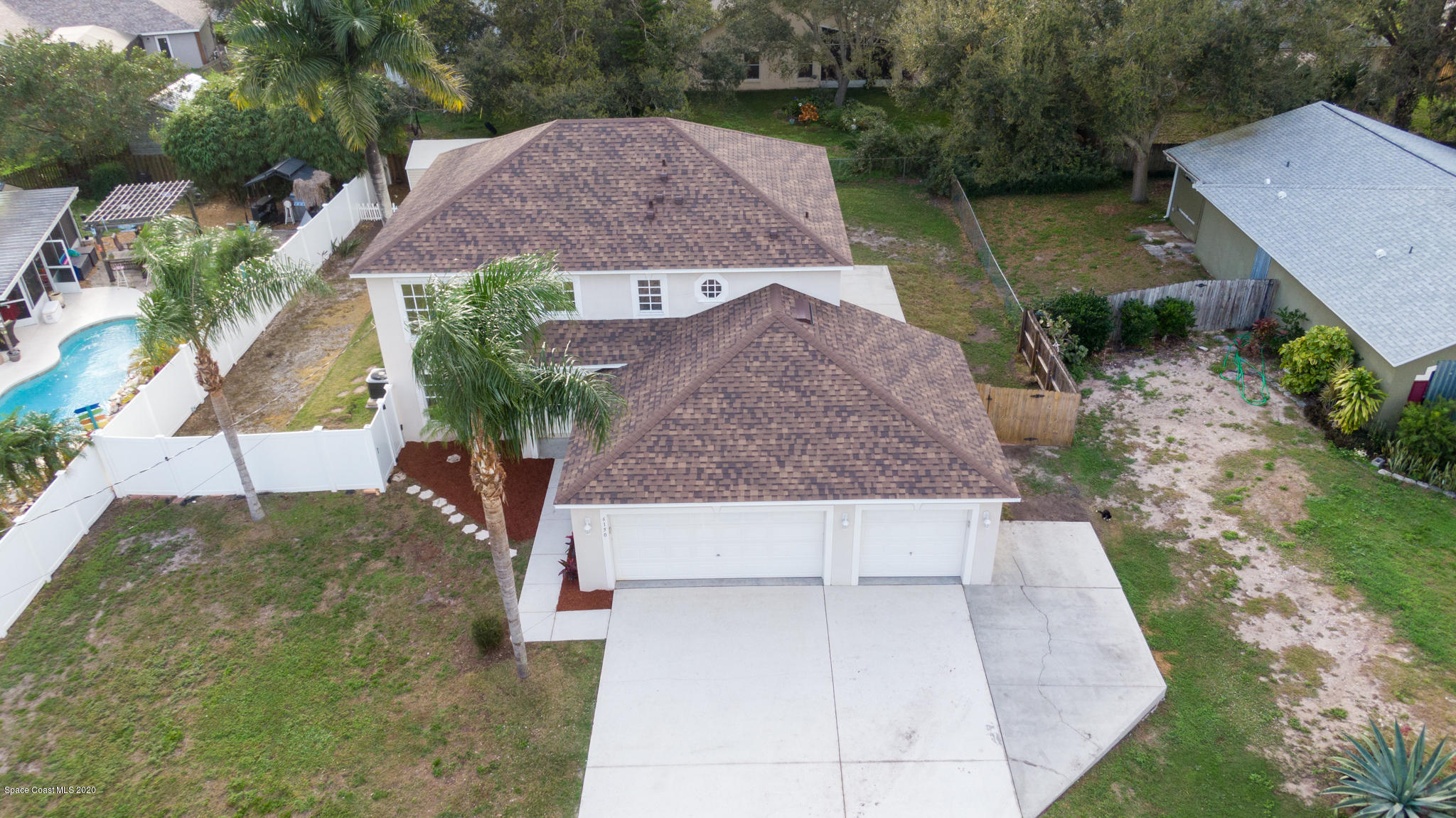 6150 Degan Road Cocoa, FL 32927 - Photo 1 of 48 an aerial view of a house with a yard