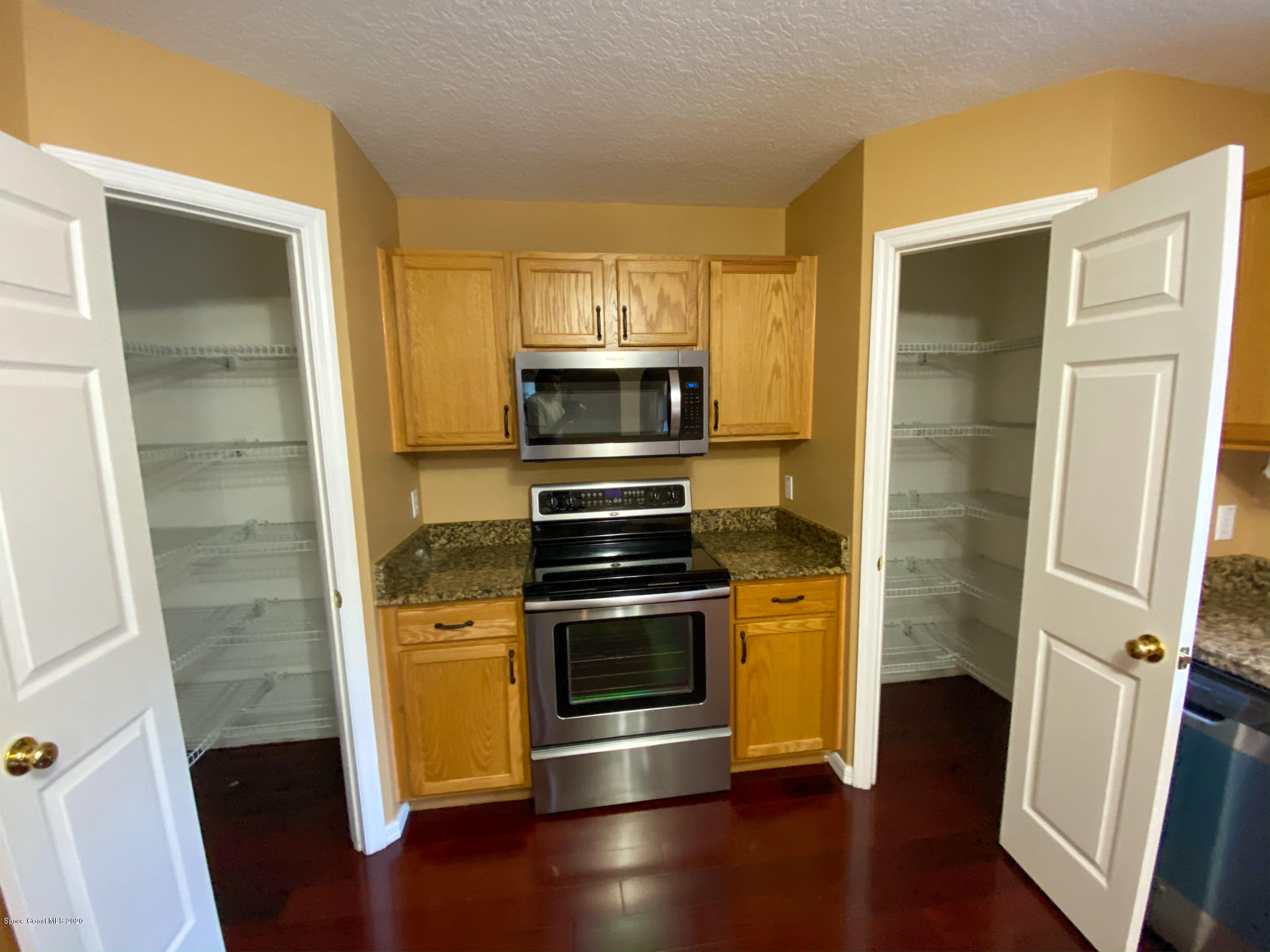 6150 Degan Road Cocoa, FL 32927 - Photo 13 of 48 a kitchen with a stove and a refrigerator