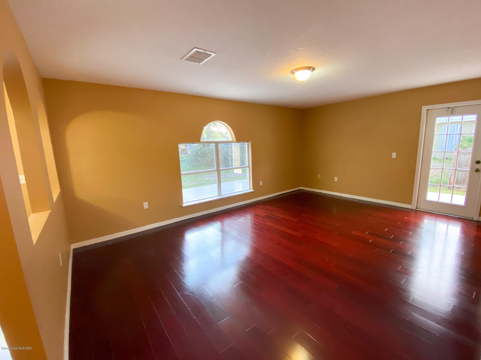 6150 Degan Road Cocoa, FL 32927 - Photo 21 of 48 a view of a room with wooden floor and window