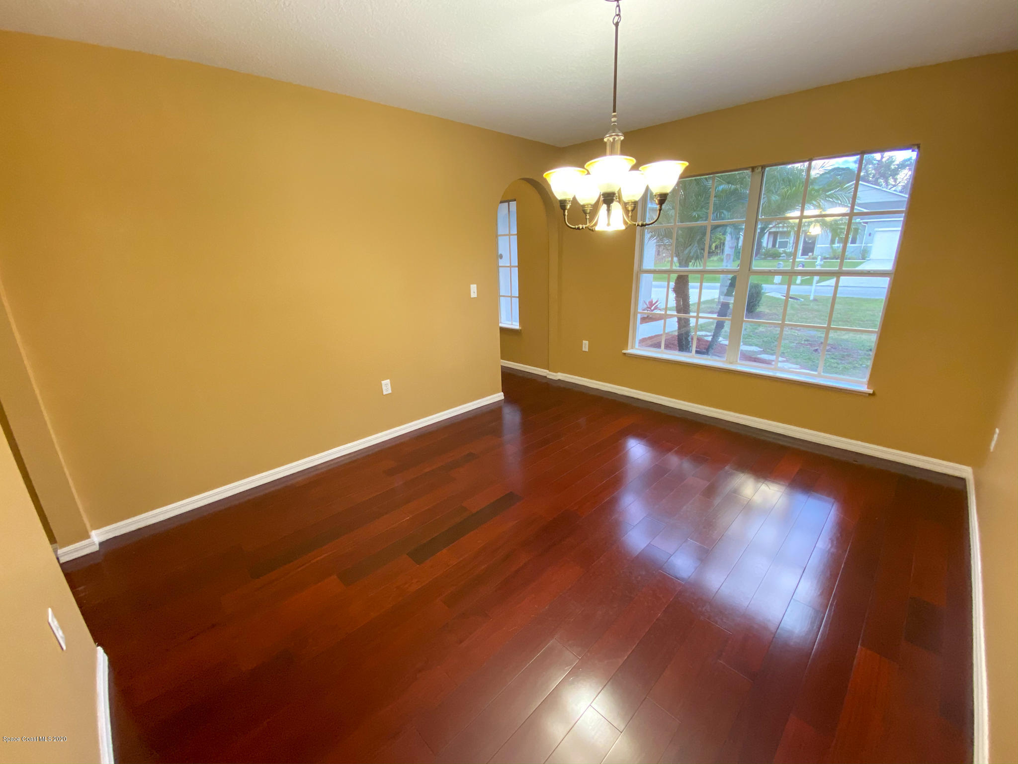 6150 Degan Road Cocoa, FL 32927 - Photo 23 of 48 a view of a room with wooden floor and chandelier