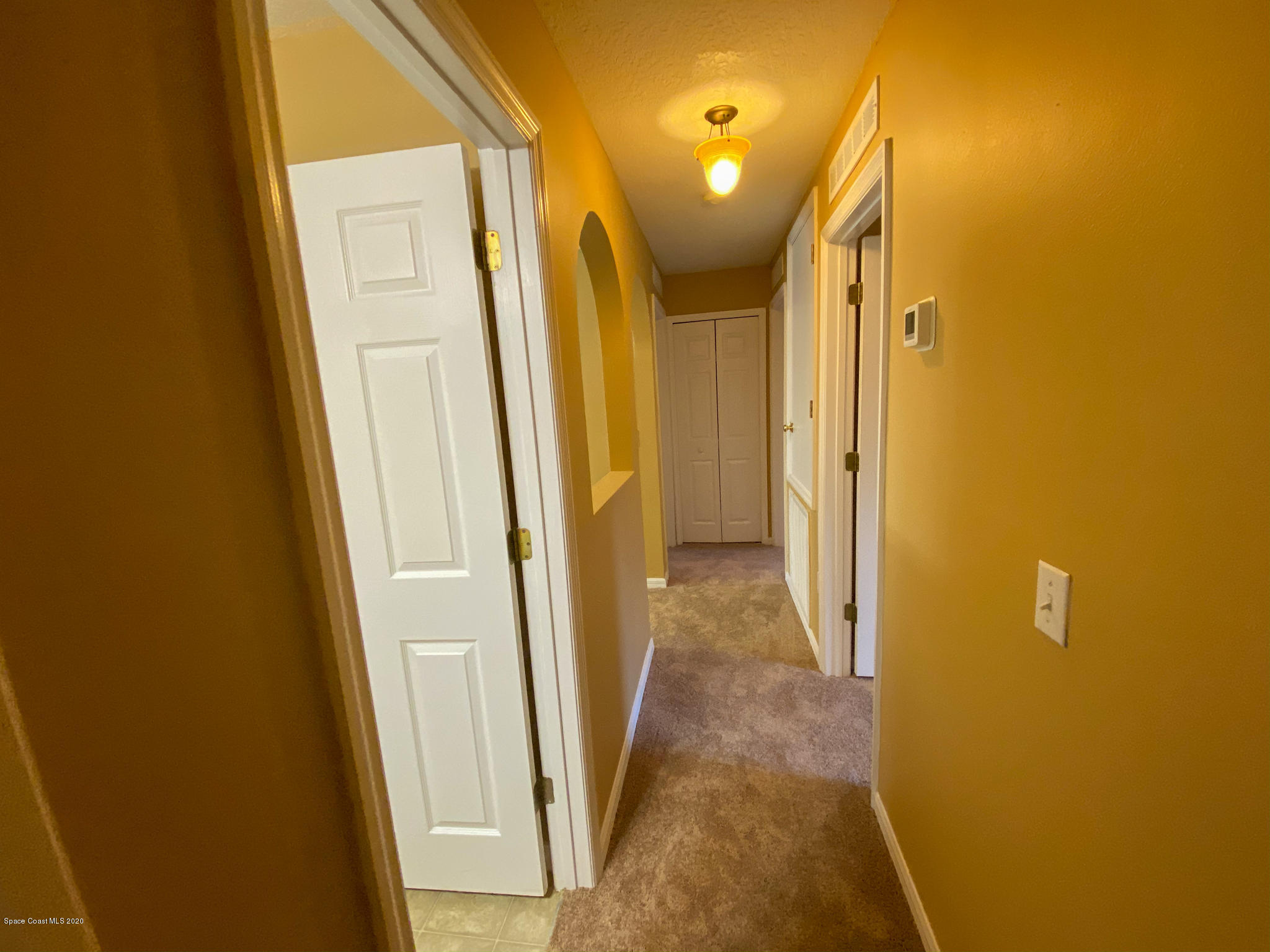 6150 Degan Road Cocoa, FL 32927 - Photo 29 of 48 a view of a hallway with wooden floor