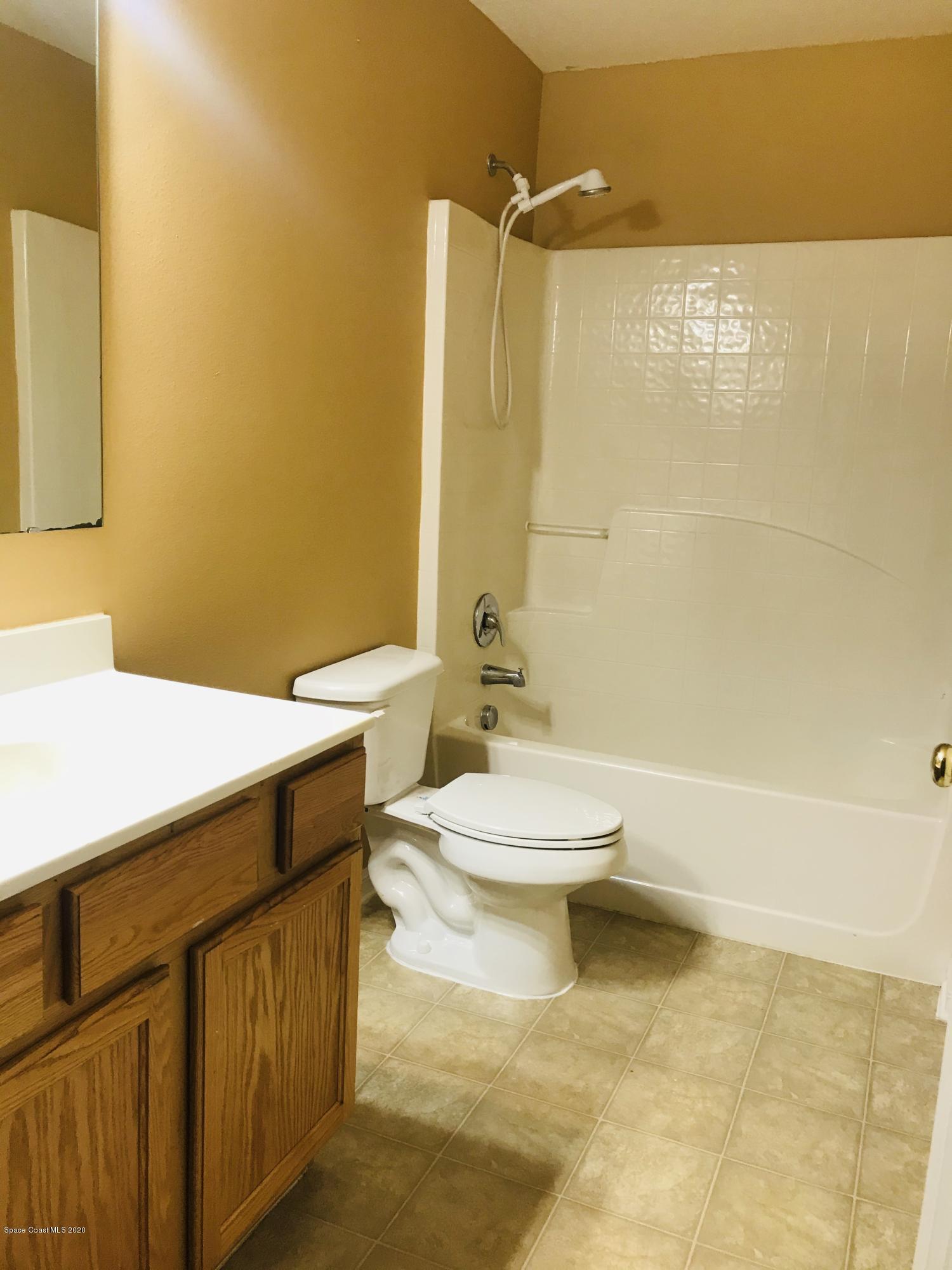 6150 Degan Road Cocoa, FL 32927 - Photo 30 of 48 a bathroom with a toilet a sink and shower