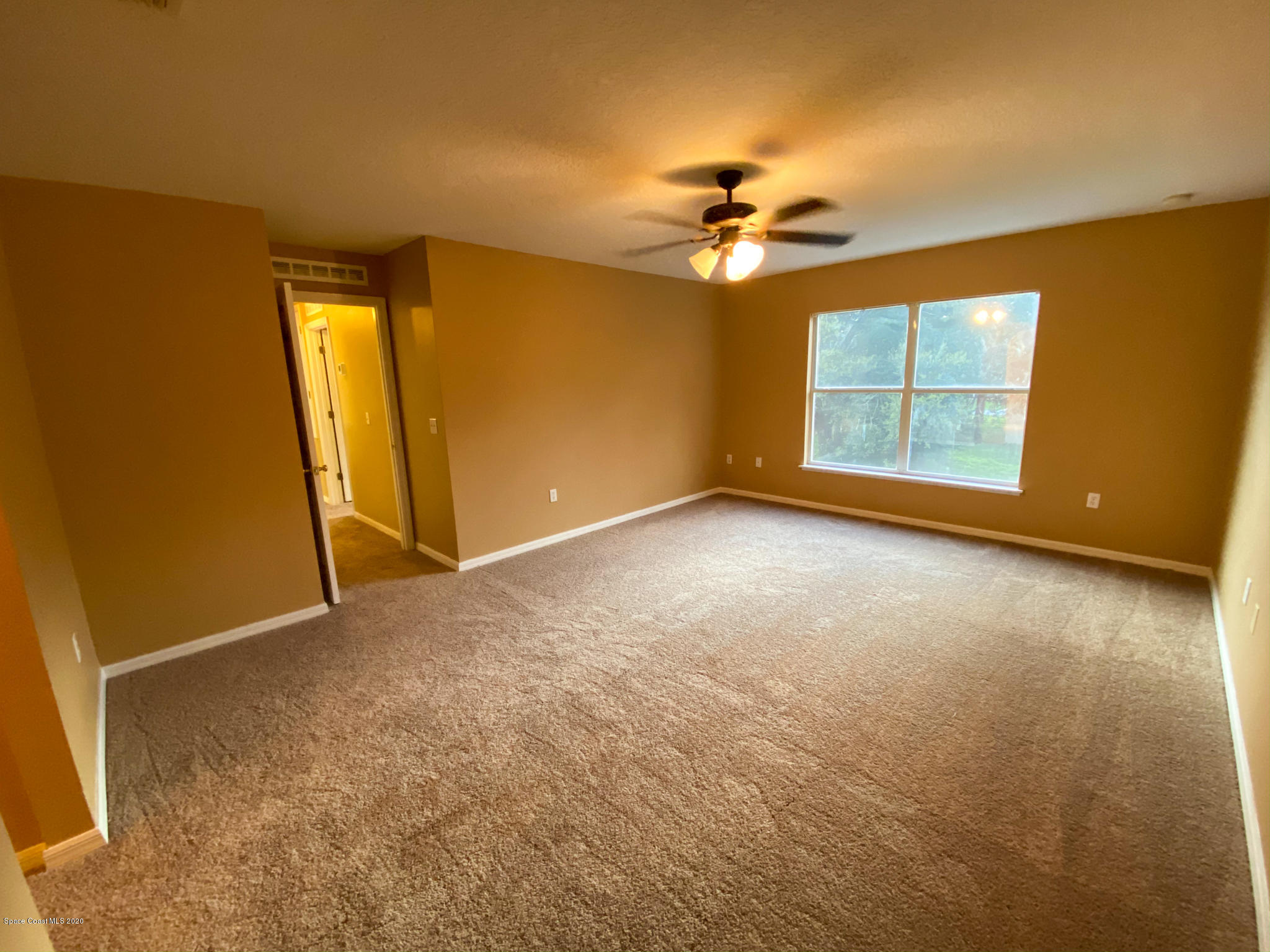 6150 Degan Road Cocoa, FL 32927 - Photo 33 of 48 an empty room with windows and chandelier fan