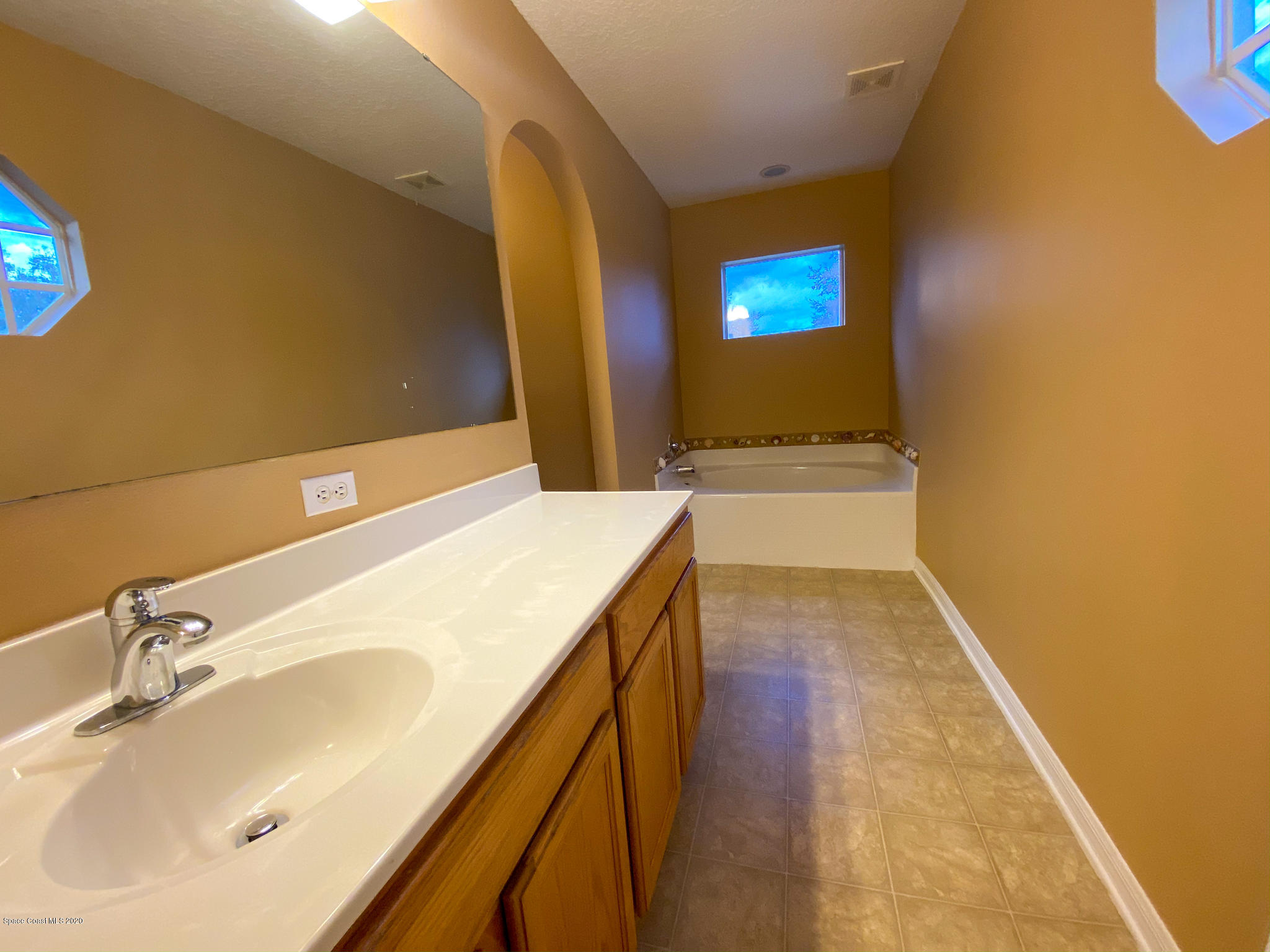 6150 Degan Road Cocoa, FL 32927 - Photo 39 of 48 a bathroom with a sink and a mirror