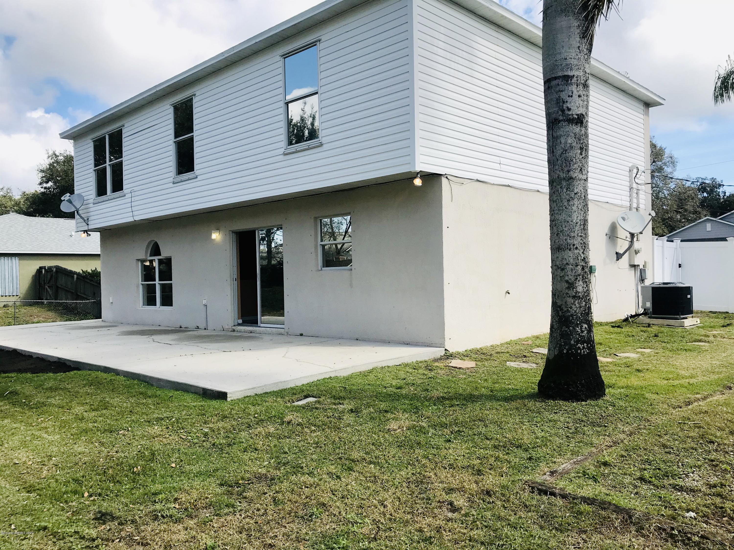 6150 Degan Road Cocoa, FL 32927 - Photo 9 of 48 a front view of a house with a yard