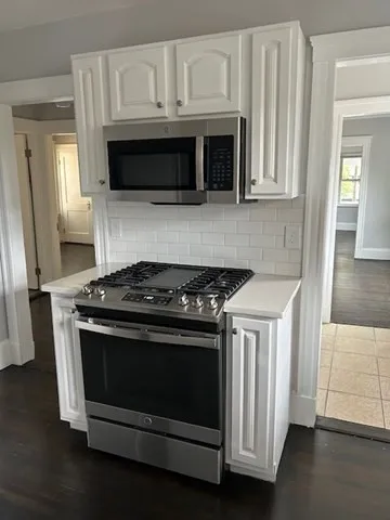 a stove top oven sitting inside of a kitchen