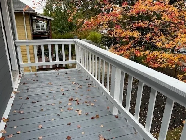a view of balcony with wooden floor and fence