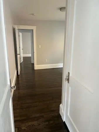 a view of hallway with wooden floor