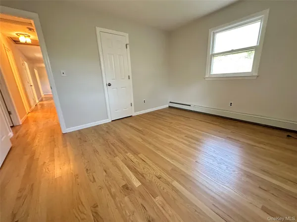 a view of a room with wooden floor and staircase