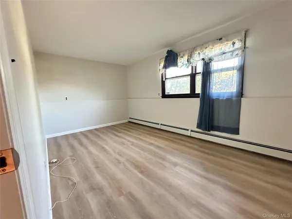 a view of empty room with window and fireplace