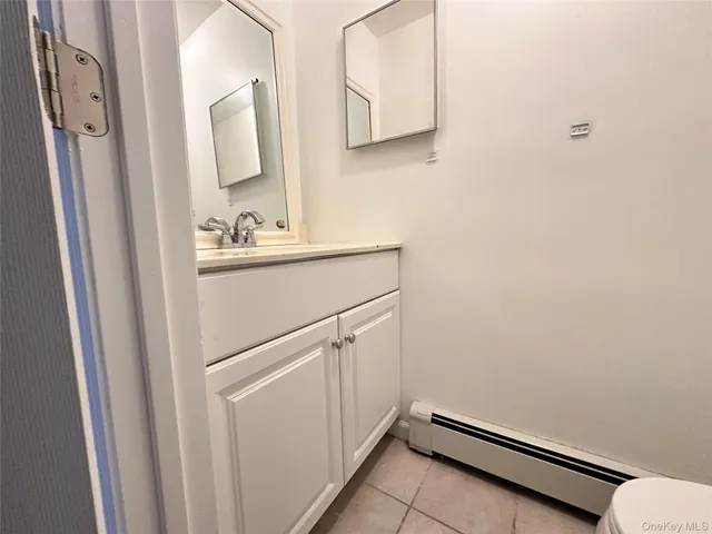 a white toilet sitting next to a white sink