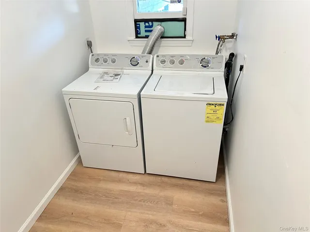 a view of a house with a wooden deck and a barbeque
