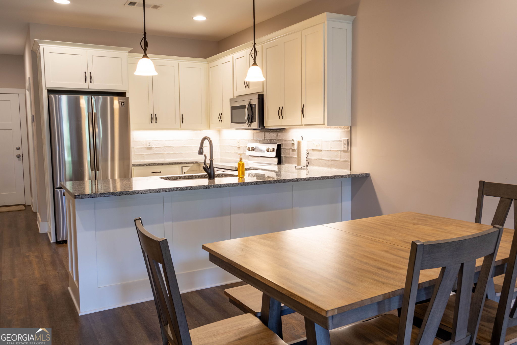 212 Old Clarkesville Mill Road, Unit C Clarkesville, GA 30523 - Photo 17 of 55 a view of a kitchen with a dining table and chairs