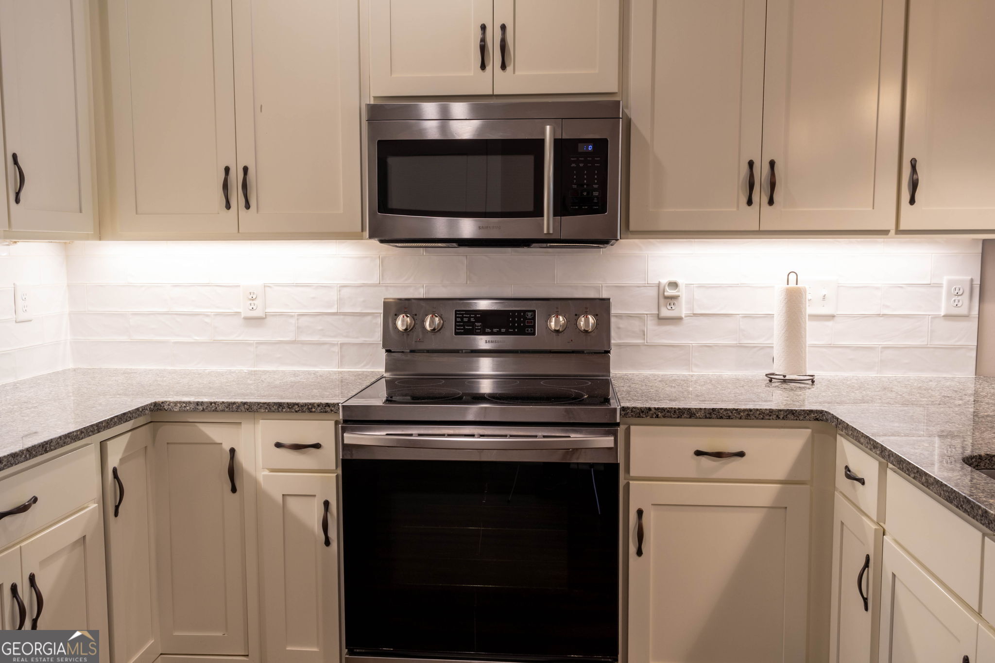 212 Old Clarkesville Mill Road, Unit C Clarkesville, GA 30523 - Photo 27 of 55 a kitchen with stainless steel appliances granite countertop a stove top oven microwave and cabinets