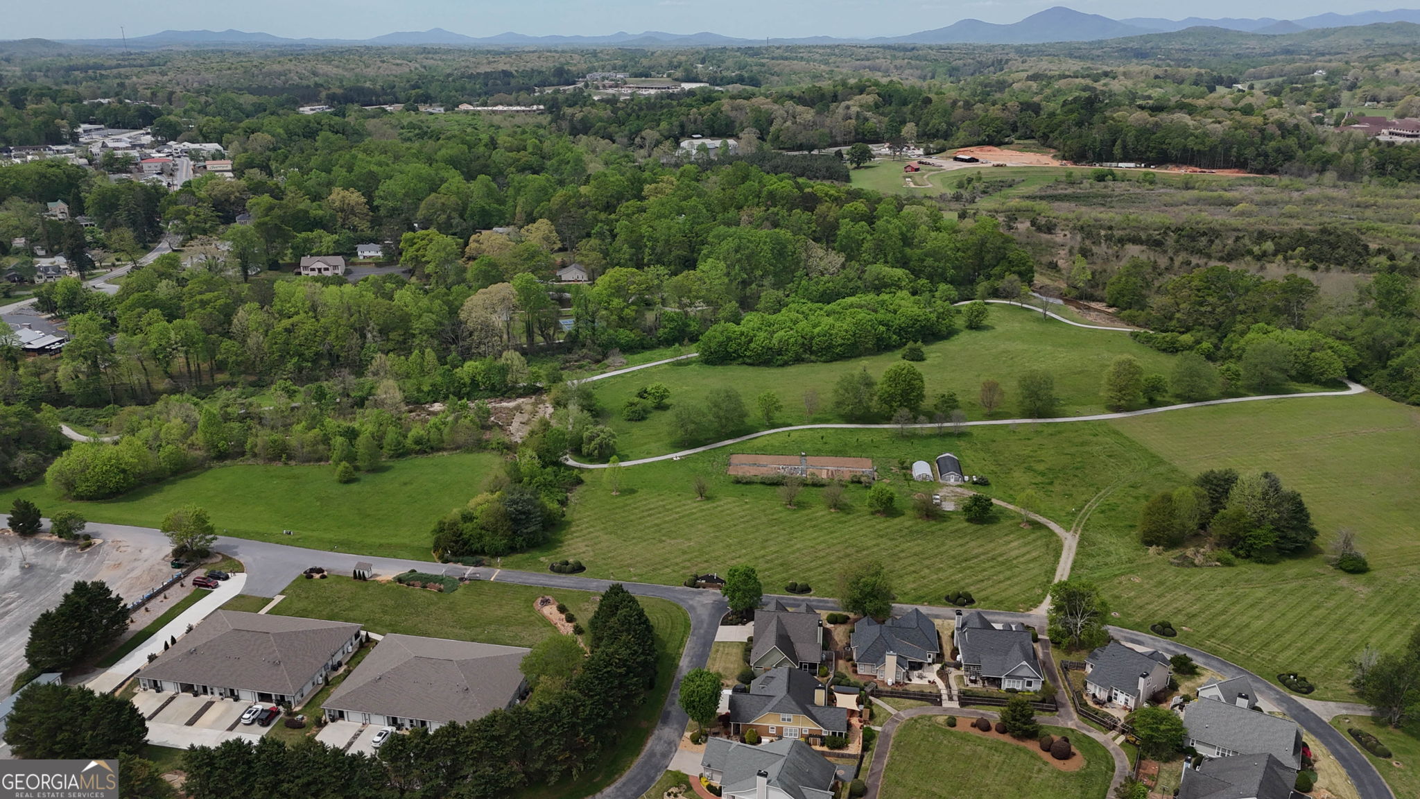 212 Old Clarkesville Mill Road, Unit C Clarkesville, GA 30523 - Photo 48 of 55 an aerial view of a houses with a lush green hillside