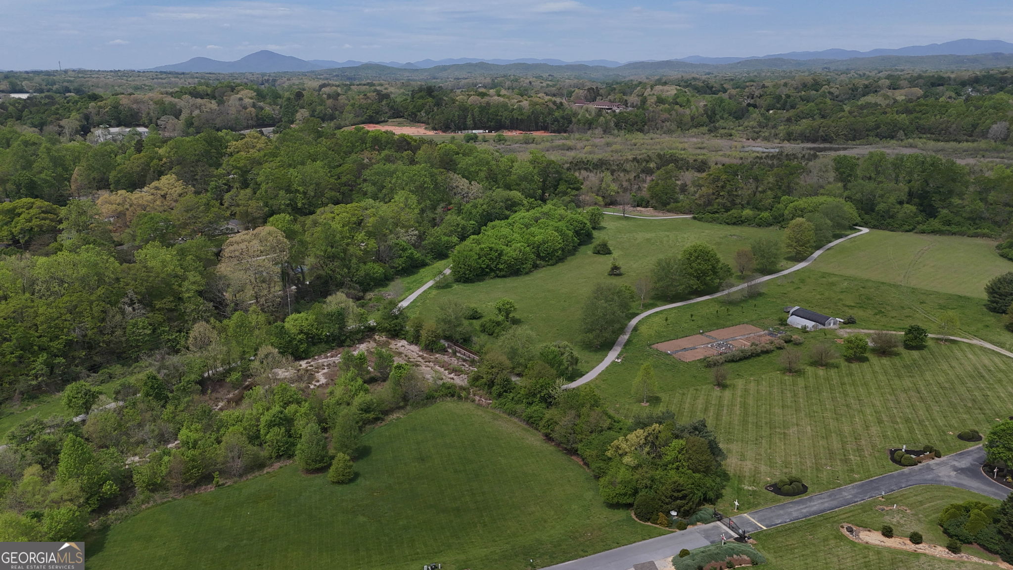 212 Old Clarkesville Mill Road, Unit C Clarkesville, GA 30523 - Photo 49 of 55 an aerial view of a houses with a lush green hillside