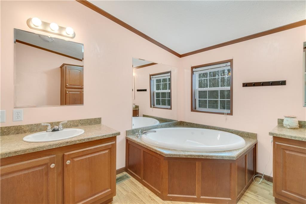 1064 Leesburg Station Road Mercer, PA 16137 - Photo 13 of 25 a bathroom with a tub sink and mirror