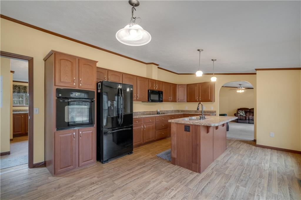1064 Leesburg Station Road Mercer, PA 16137 - Photo 4 of 25 a kitchen with stainless steel appliances granite countertop a refrigerator a stove top oven a sink dishwasher and wooden cabinets