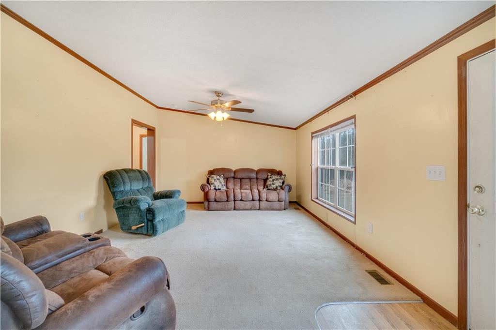 1064 Leesburg Station Road Mercer, PA 16137 - Photo 8 of 25 a living room with furniture a chandelier and a window